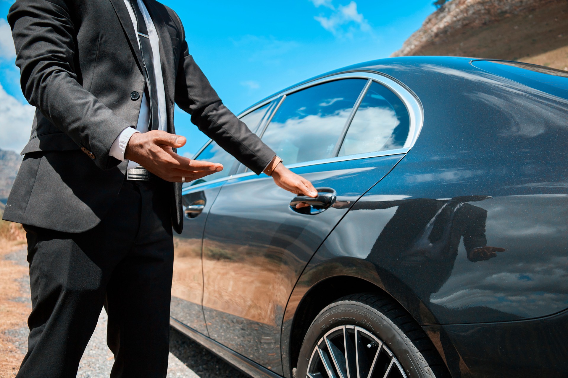 Elegant Businessman in Suit Opening Luxury Car Door